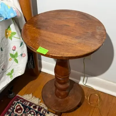 Sale Photo Thumbnail #293: Vintage round wooden pedestal side table featuring a turned central column and a heavy circular base.