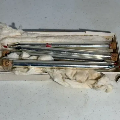 Sale Photo Thumbnail #408: Set of vintage mercury glass bubble light replacement tubes with cork stoppers, housed in their original cotton-lined box.
