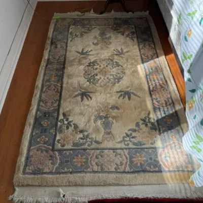 Sale Photo Thumbnail #296: Vintage Chinese Nichols-style wool area rug featuring a central floral medallion, urn motifs, and a patterned border in muted tones.