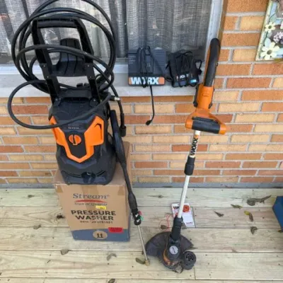 Sale Photo Thumbnail #205: Collection of power outdoor equipment including a Stream pressure washer with box, a Worx electric string trimmer, battery chargers, and an electric demolition hammer.