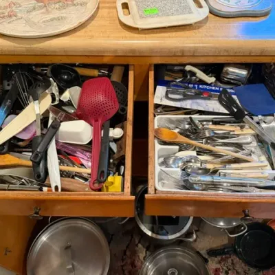 Sale Photo Thumbnail #315: Two wooden kitchen drawers filled with various cooking utensils, flatware organizers, and kitchen gadgets.