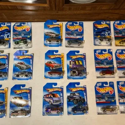 Sale Photo Thumbnail #88: Collection of 18 vintage packaged Hot Wheels die-cast toy cars from the 1990s and early 2000s, including First Editions and various vehicle models.