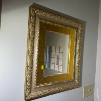 Sale Photo Thumbnail #140: Vintage ornate wall mirror featuring a multi-tiered gold leaf and textured frame.