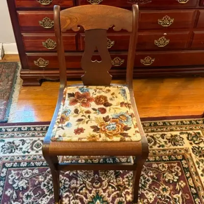 Sale Photo Thumbnail #166: Vintage dark wood side chair featuring a heart cut-out back detail and a floral tapestry-style padded seat.