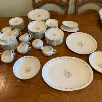 Sale Photo Thumbnail #23: Large vintage fine china dinnerware service with subtle floral motif and silver trim, including plates, bowls, teacups, platters, and serving pieces.