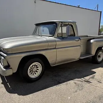 Sale Photo Thumbnail #2: Vintage 1960s Chevrolet C10 step-side pickup truck finished in metallic silver with custom wheels.