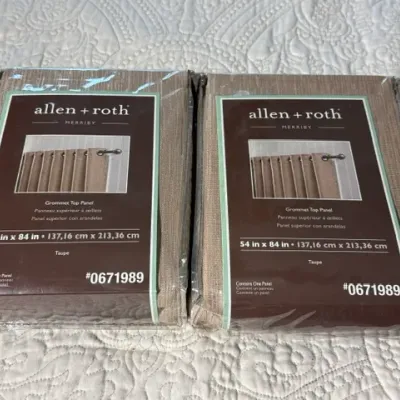 Sale Photo Thumbnail #155: Two new-in-package Allen + Roth Merriby grommet top curtain panels in taupe, measuring 54 inches by 84 inches.
