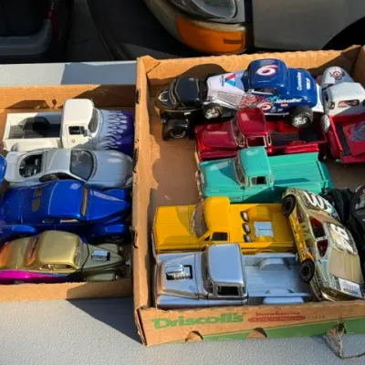 Sale Photo Thumbnail #457: Collection of die-cast model cars and pickup trucks packed in cardboard trays, including vintage hot rods, stock cars, and classic trucks.