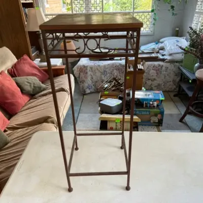 Sale Photo Thumbnail #241: Tall wrought iron plant stand with a square wood insert top and scrollwork detailing.