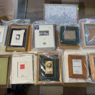 Sale Photo Thumbnail #189: Large assortment of picture frames in various sizes and finishes, many individually wrapped in plastic bags.
