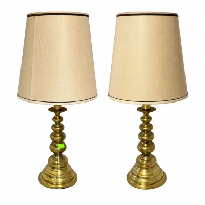 Sale Photo Thumbnail #292: Pair of vintage brass table lamps featuring turned, multi-baluster bases and beige fabric shades with dark trim.