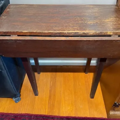 Sale Photo Thumbnail #290: Vintage dark stained wooden drop-leaf side table, showing significant finish wear and scratching on top surface.