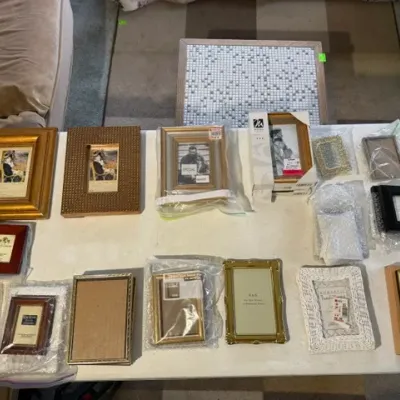 Sale Photo Thumbnail #190: Collection of assorted picture frames in various sizes, finishes, and materials including wood, metallic gold, and white wicker.