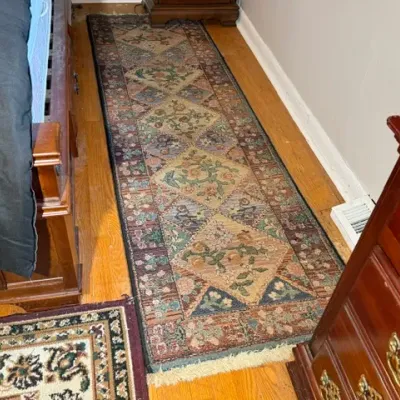 Sale Photo Thumbnail #171: Traditional woven runner rug featuring a diamond geometric and floral pattern in muted earth tones, laid over hardwood flooring.