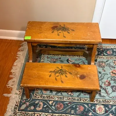 Sale Photo Thumbnail #151: Vintage hand-painted wooden two-step stool with floral detail on light pine finish, showing light surface wear.
