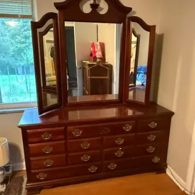 Sale Photo Thumbnail #158: Traditional cherry wood triple dresser with a tri-fold vanity mirror and brass batwing hardware.