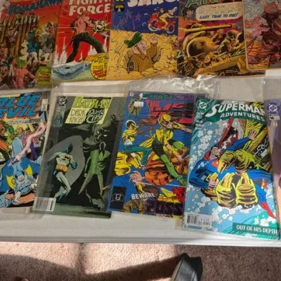 Sale Photo Thumbnail #430: Collection of vintage comic books featuring titles from DC Comics, Impact Comics, and war genres, including Blue Devil, Batman, and Superman Adventures.
