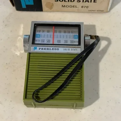 Sale Photo Thumbnail #232: Vintage Peerless Solid State Model 870 portable transistor radio in avocado green plastic casing with original carrying strap and box.