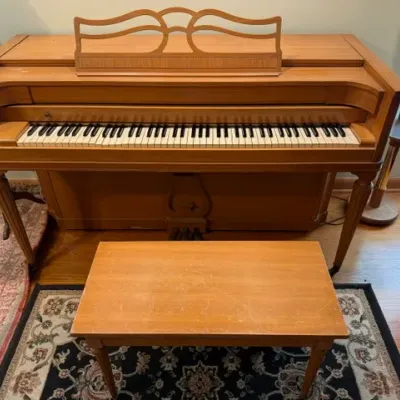 Sale Photo Thumbnail #6: Mid-century Baldwin spinet piano with a matching light wood bench and ornate music stand.