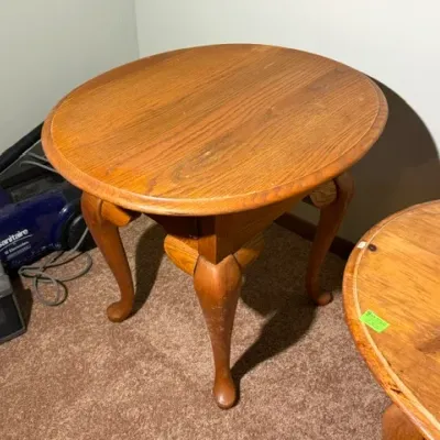 Sale Photo Thumbnail #324: Round traditional oak side table featuring cabriole legs and Queen Anne-style feet, showing minor surface wear.