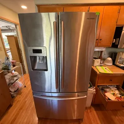 Sale Photo Thumbnail #299: Samsung stainless steel French door refrigerator with exterior ice and water dispenser and bottom freezer drawer.