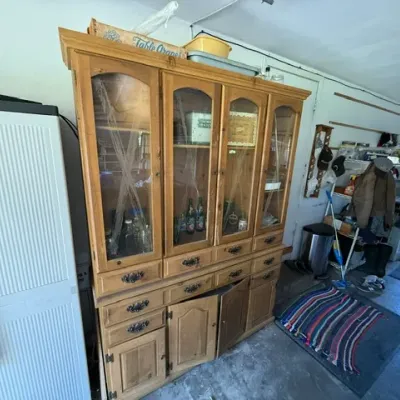 Sale Photo Thumbnail #484: Large rustic pine china hutch with glass-front upper doors, multiple drawers, and bottom cabinet storage.