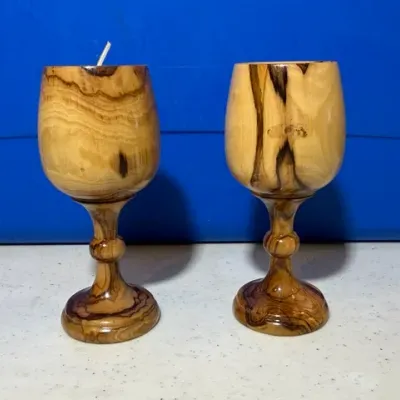 Sale Photo Thumbnail #59: Pair of hand-turned olive wood goblets featuring prominent natural graining and polished finishes.