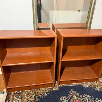 Sale Photo Thumbnail #138: Matching pair of modern low cherry-finished wooden bookcases with adjustable shelves.