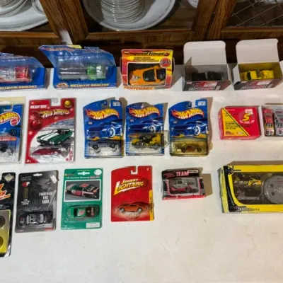 Sale Photo Thumbnail #80: Collection of vintage packaged die-cast toy cars, including Hot Wheels, Matchbox, Johnny Lightning, and Motor Works vehicles in original blister packs and boxes.