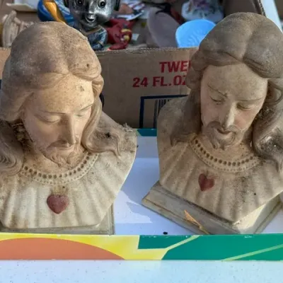 Sale Photo Thumbnail #455: Pair of vintage Sacred Heart of Jesus chalkware bust statues with painted details, showing age-related dust and wear.