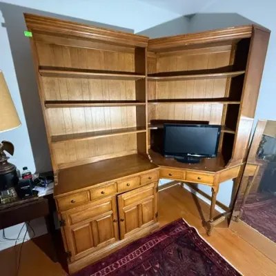 Sale Photo Thumbnail #287: Two-piece wooden corner hutch unit featuring a straight credenza base with upper display shelves alongside an L-shaped corner desk attachment.