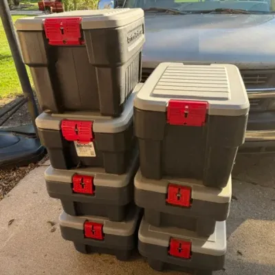 Sale Photo Thumbnail #459: Stack of seven heavy-duty Rubbermaid ActionPacker plastic storage totes with red latching handles.
