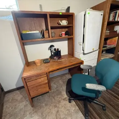 Sale Photo Thumbnail #362: Vintage wooden desk with attached hutch and drawers, paired with a teal fabric rolling office chair.