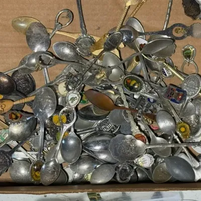 Sale Photo Thumbnail #414: Large cardboard box filled with a assorted collection of vintage souvenir and decorative collector spoons.