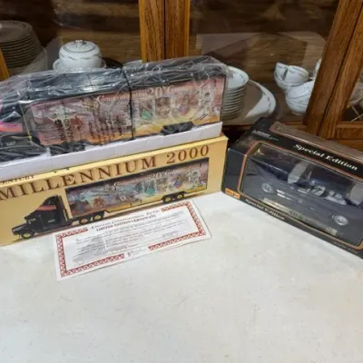 Sale Photo Thumbnail #105: Limited edition Millennium 2000 toy semi-truck in original box with certificate alongside a Maisto 1:18 scale Special Edition die-cast car.