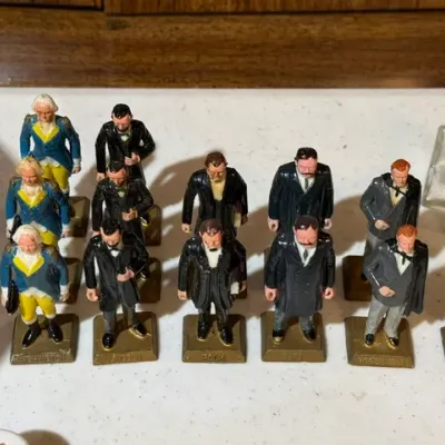Sale Photo Thumbnail #112: Collection of vintage Marx painted lead or plastic U.S. President miniature figurines on labeled gold bases.