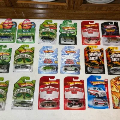 Sale Photo Thumbnail #92: Collection of 17 Hot Wheels holiday and themed die-cast cars in original blister packaging, including Easter Eggsclusives, Clover Cars, Valentine's Day, and Summer Racin' editions.