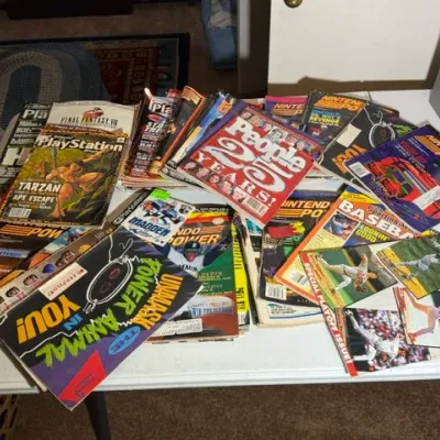 Sale Photo Thumbnail #334: Large collection of vintage magazines from the 1990s, including Nintendo Power, Official PlayStation Magazine, People, and various sports publications.