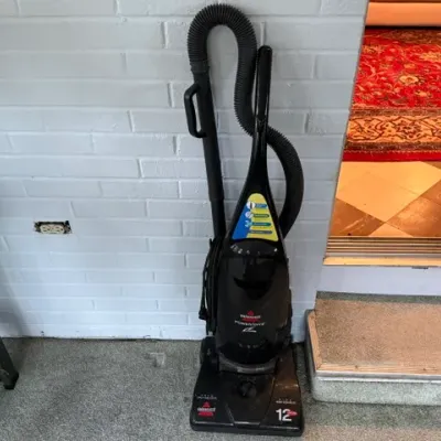 Sale Photo Thumbnail #212: Bissell PowerForce upright vacuum cleaner in black plastic finish.