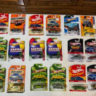 Sale Photo Thumbnail #79: Collection of 18 packaged Hot Wheels and Matchbox die-cast toy cars, including Classics, Easter Eggclusives, Clover Cars, and Wayne's Garage series.