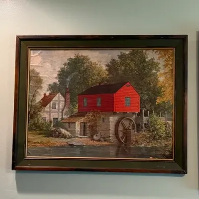 Sale Photo Thumbnail #9: Framed vintage landscape art print depicting a red watermill alongside a millpond, set in a dark wooden frame.