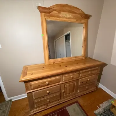 Sale Photo Thumbnail #143: Rustic knotty pine dresser with matching arched attachment mirror, multiple drawers, and center cabinet door.