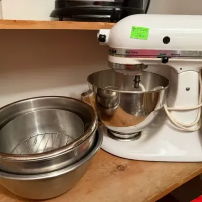 Sale Photo Thumbnail #272: White KitchenAid Ultra Power tilt-head stand mixer with a stainless steel bowl, alongside a nested stack of stainless steel mixing bowls.