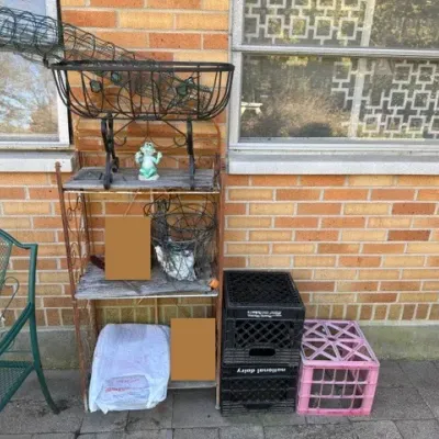 Sale Photo Thumbnail #496: Vintage metal baker's rack with wire planters, small decorative frog statue, and plastic milk crates resting on a patio.
