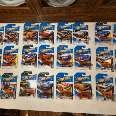 Sale Photo Thumbnail #76: Collection of packaged Hot Wheels die-cast toy vehicles displayed on a flat surface.