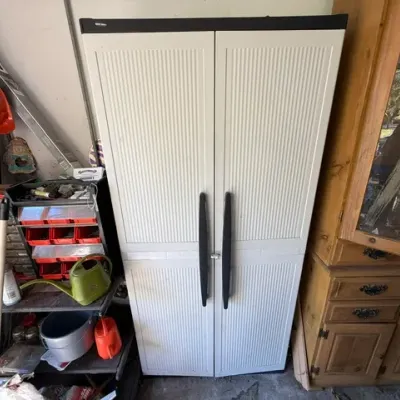 Sale Photo Thumbnail #482: Tall white molded resin utility storage cabinet with black handles, ideal for garage or workshop organization.