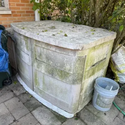 Sale Photo Thumbnail #491: Large molded resin outdoor storage shed cabinet showing weather wear and moss staining.