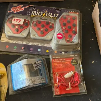 Sale Photo Thumbnail #471: Collection of packaged vintage car accessories, including Street Glow Indiglo light-up sport pedals, Audiobahn connections, and car stereo connectors.