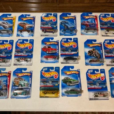 Sale Photo Thumbnail #84: Collection of sixteen carded Hot Wheels die-cast toy vehicles, primarily featuring classic cars and motorcycles from the late 1990s and early 2000s series.