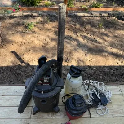 Sale Photo Thumbnail #206: Craftsman 6-gallon wet/dry shop vacuum with attachments, alongside a pump sprayer and a block-and-tackle pulley with rope.